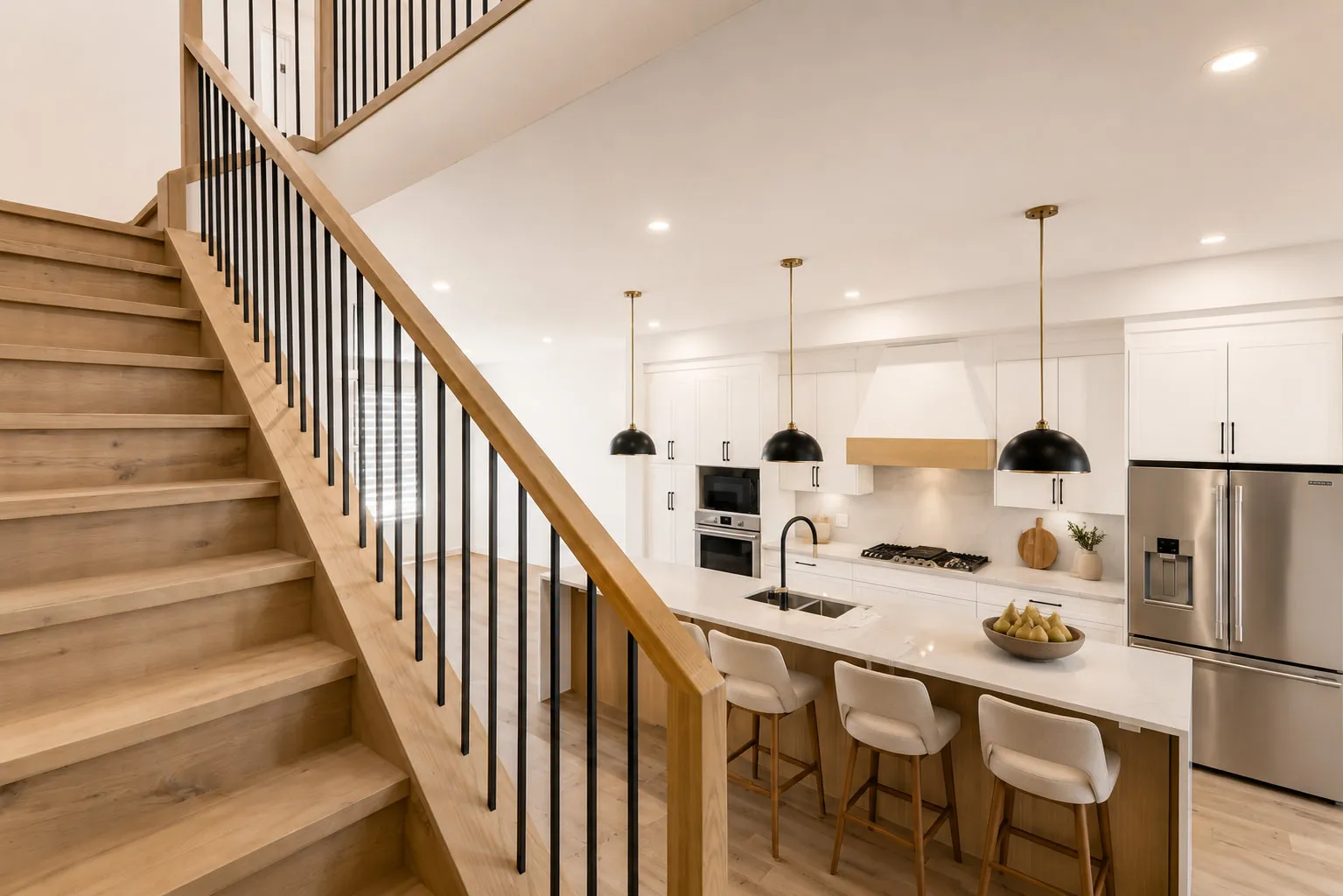 An open staircase overlooking the kitchen island of a Calgary rental home